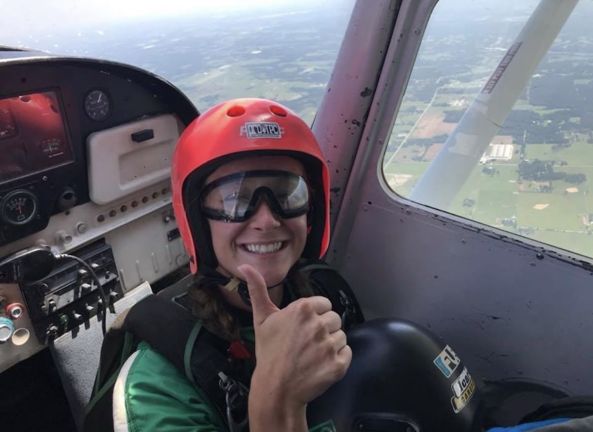 Author Cecilia Malise sitting in airplane before skydive