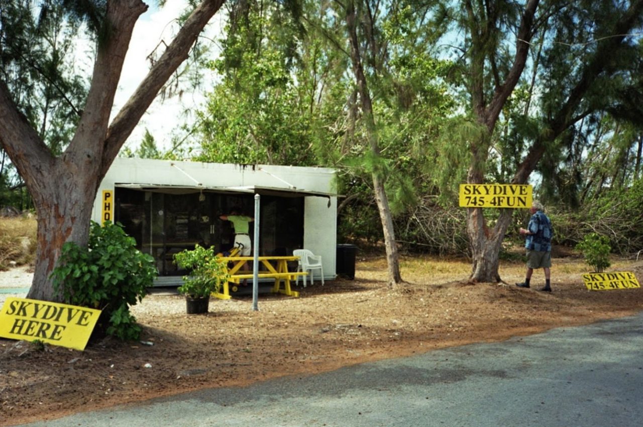 The manifest building for Skydive Key West in 1999 with Yellow signs outside that say "skydive here"