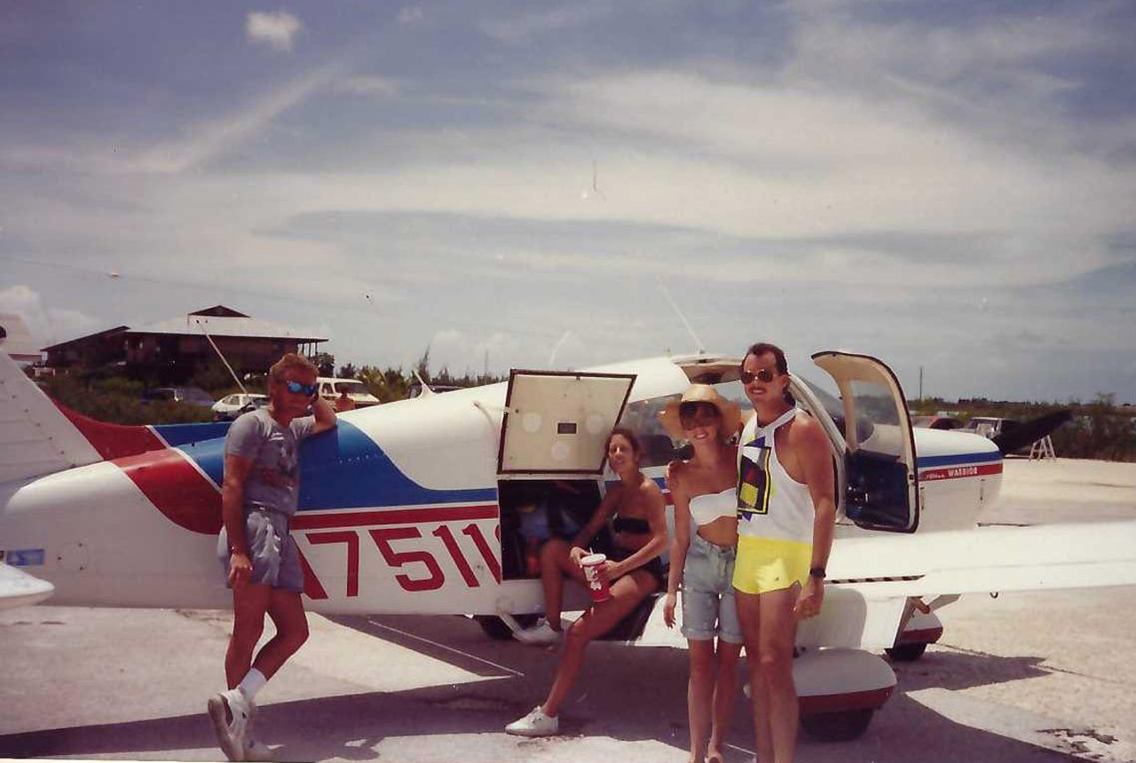 Group of people hanging out next to an airplane at Skydive Key West in 1991