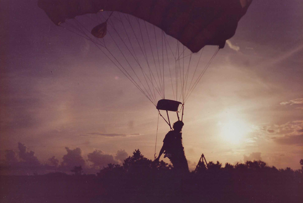experienced jumper coming in for landing with the sunsetting in the distance at skydive key west in 1991