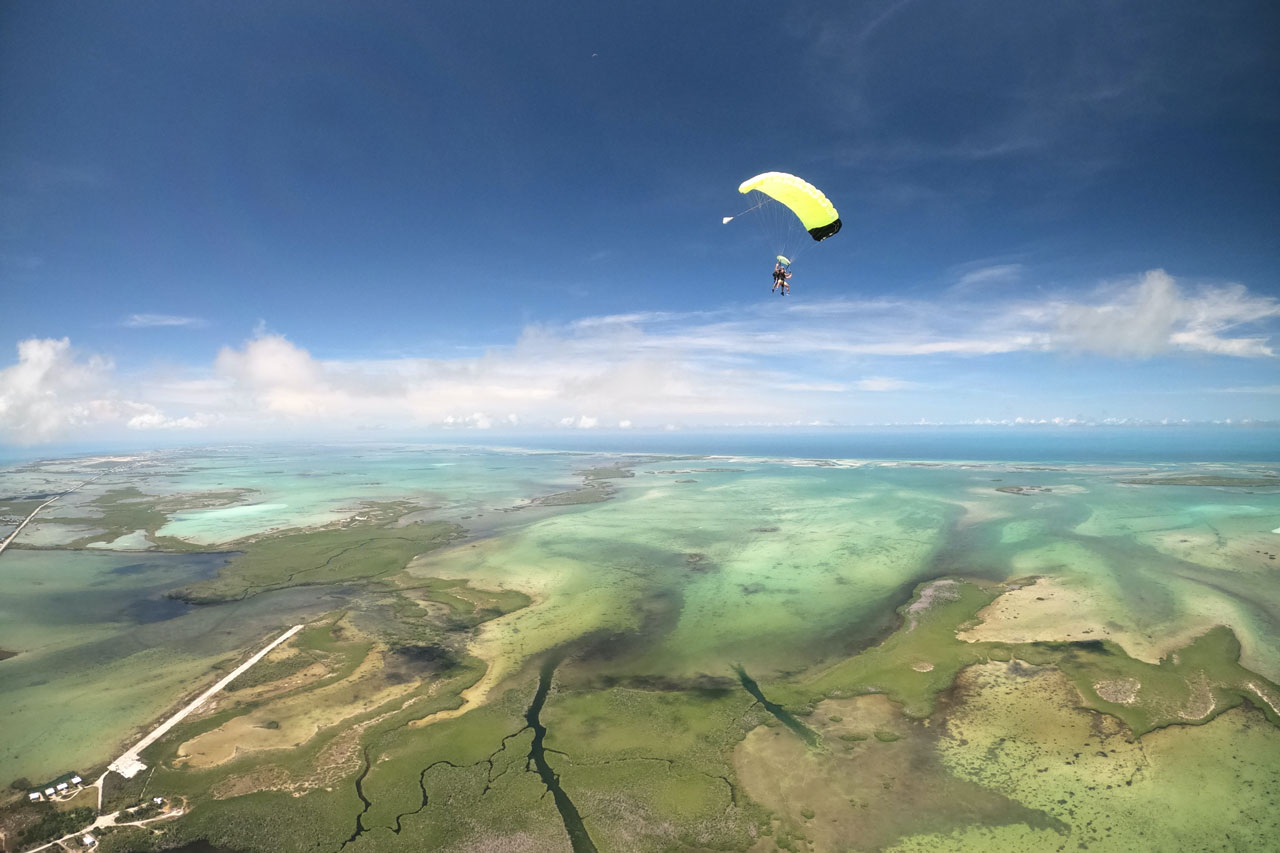 Beautiful aerial view of Florida Keys skydiving with tandem skydiver under canopy off in the distance