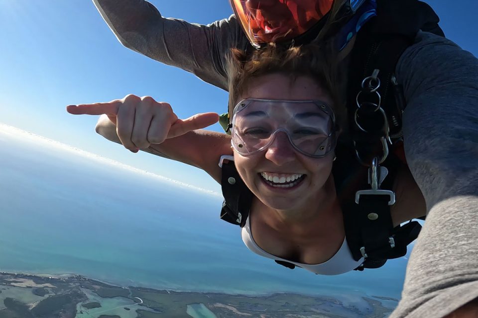 Young female tandem jumper smiling while enjoying Skydiving South Florida