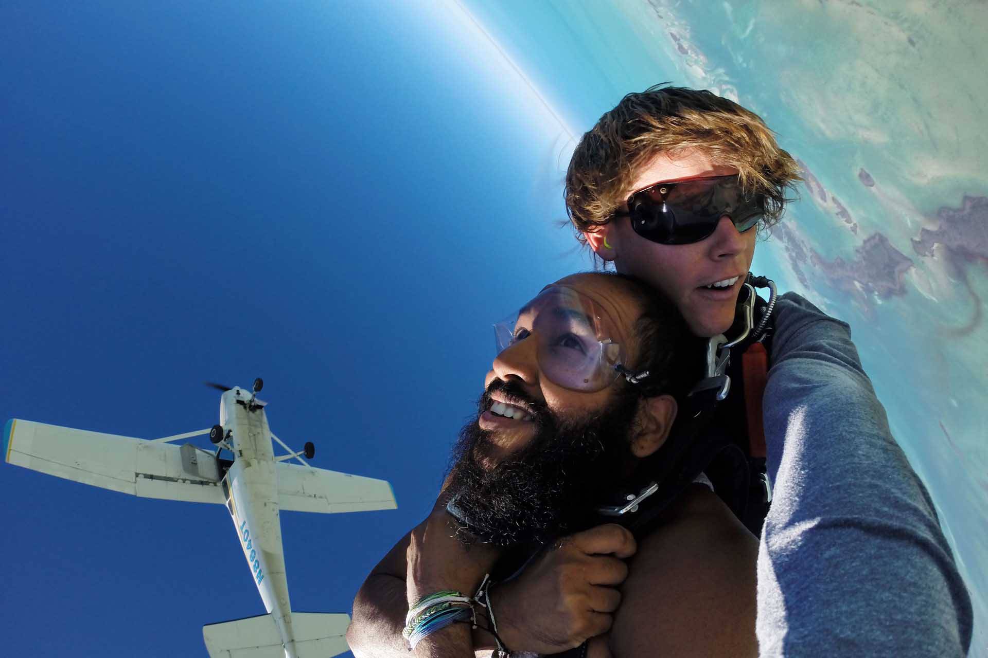 Male tandem skydiving student and instructor in freefall over the Florida Keys