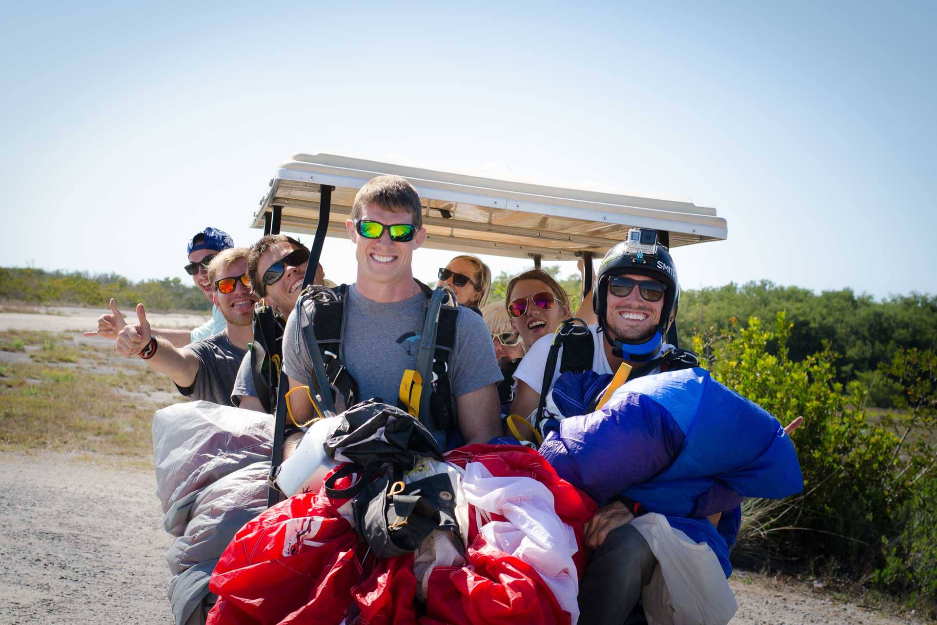 Group of skydivers riding in a golf cart at Skydive Key West 