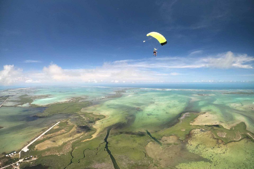 Beautiful aerial view of Florida Keys skydiving with tandem skydiver under canopy off in the distance