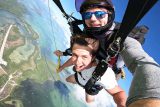 Young man wearing white shirt enjoys Florida Keys Skydiving