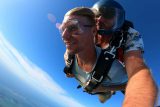 Young man wearing blue shirt enjoys Florida Keys Skydivingjoys his