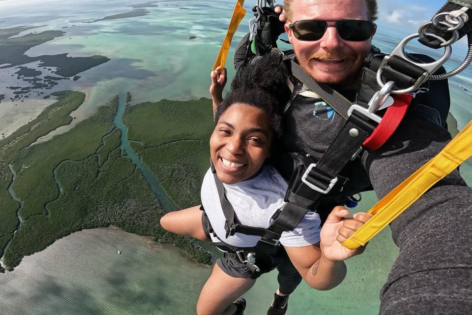 Female and male tandem pair skydiving in scenic Key West.