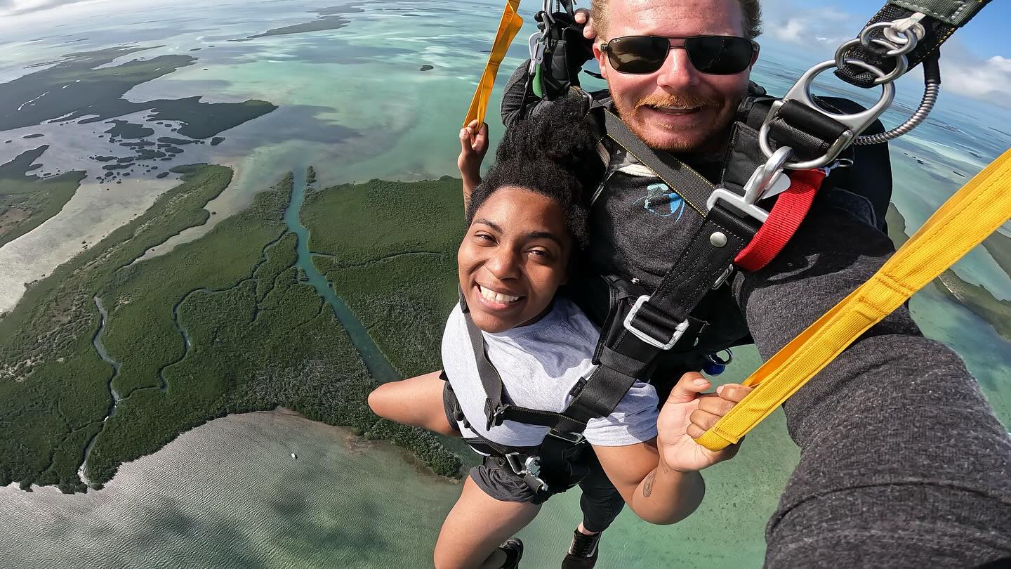 Female and male tandem pair skydiving in scenic Key West.