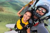 Young female wearing yellow shirt smiles as she enjoys Florida Keys Skydiving