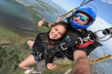 Female tandem skydiver with her instruction - two thumbs up over Skydive Key West